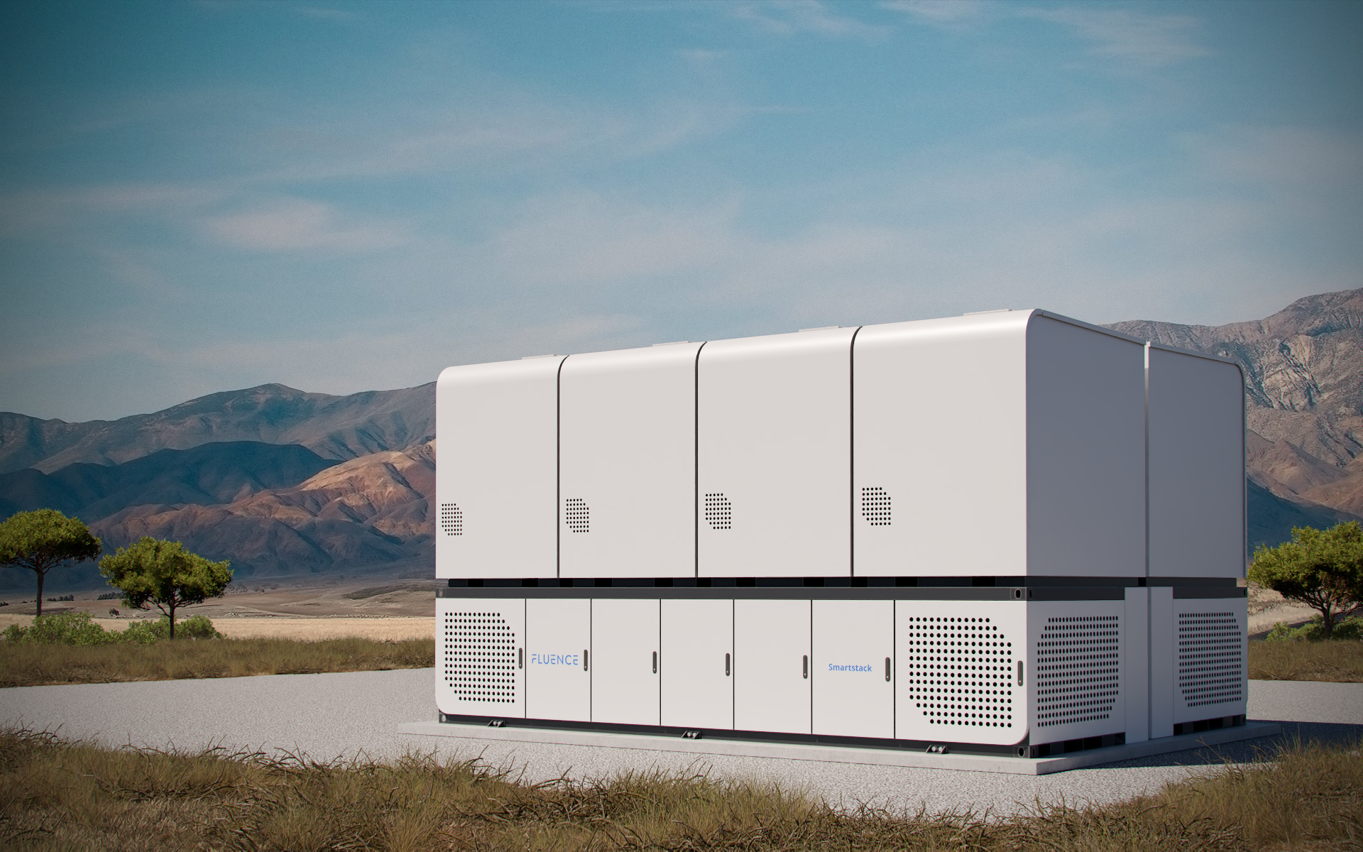 Large Smartstack battery energy storage system from ground level on gravel with mountains and blue sky in background